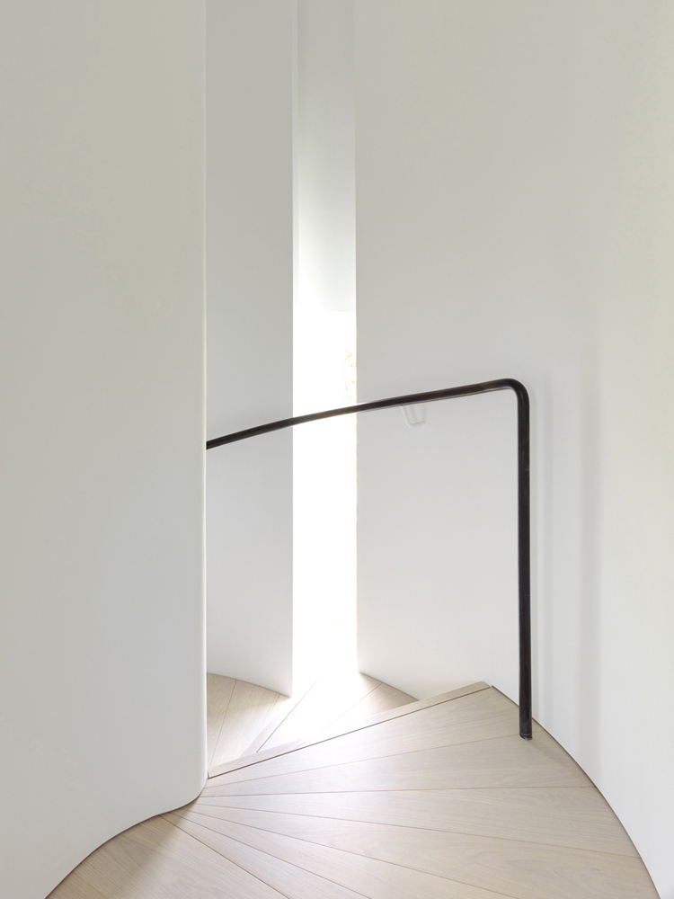 Curved Stair and Light with Black Handrail